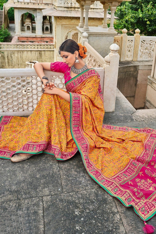 Yellow Banarasi pure silk saree with heavy aanchal pink border and printed blouse (Unstitched)