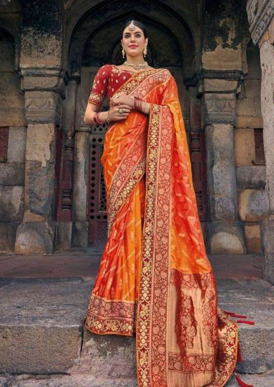 Orange pure silk saree with golden border and Red colored blouse (Unstitched)