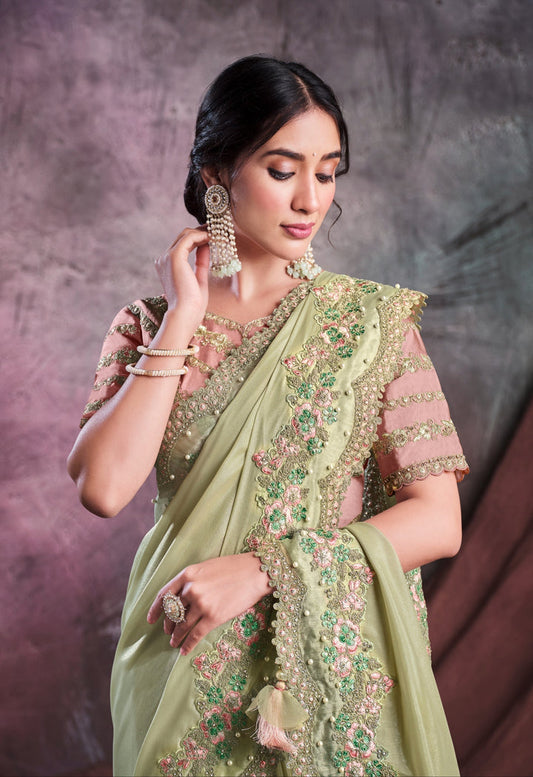 Pastel green pure silk saree with heavy aanchal golden border and nude pink printed blouse (Unstitched)