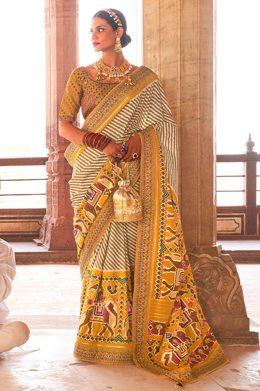 Yellow Patola pure silk saree with heavy aanchal golden border and printed blouse (Unstitched)