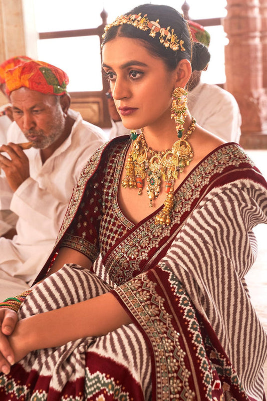 Maroon Patola pure silk saree with heavy aanchal golden border and printed blouse (Unstitched)